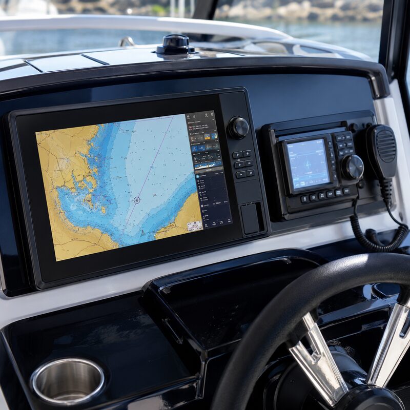 Marine GPS chartplotter and VHF radio mounted at a boat helm