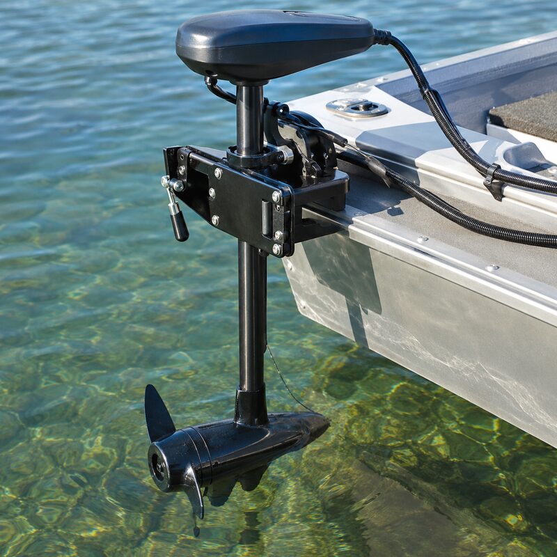 Electric trolling motor mounted on the transom of a boat in clear water